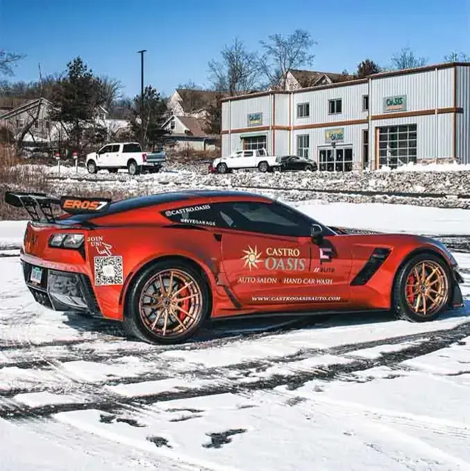 The shop's own Corvette on snow in printed Castro Oasis livery reading Auto Salon and Hand Car Wash.